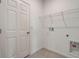 Laundry room featuring a door, a wire rack shelf, and washer/dryer hookups at 894 Pebble Crest Ln, Eagle Lake, FL 33839