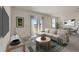 Bright and airy living room featuring modern furniture, a large window, and sliding glass doors at 894 Pebble Crest Ln, Eagle Lake, FL 33839