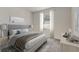 Serene main bedroom with soft natural light, neutral tones, and a plush upholstered headboard at 894 Pebble Crest Ln, Eagle Lake, FL 33839