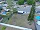 Aerial view of the backyard with a pool, mature trees, and a covered patio area, offering a private outdoor oasis at 909 Royalton Rd, Orlando, FL 32825