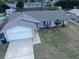 Aerial view of a well-maintained home with an attached two-car garage and manicured landscaping, showcasing curb appeal at 909 Royalton Rd, Orlando, FL 32825