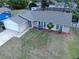 Aerial view of a single-story home featuring a manicured lawn, mature landscaping, and an attached two-car garage at 909 Royalton Rd, Orlando, FL 32825