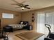 Neutral-toned bedroom featuring tiled floors, ceiling fan, and large sliding glass doors allowing for natural light at 909 Royalton Rd, Orlando, FL 32825