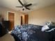 Bedroom with a fan, tan walls, and two interior doors at 909 Royalton Rd, Orlando, FL 32825
