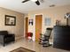 Well lit living room with tile floor, chair and decorative objects at 909 Royalton Rd, Orlando, FL 32825