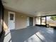 Covered patio features a painted floor, white door, and sliding glass doors, providing an ideal space for outdoor relaxation at 909 Royalton Rd, Orlando, FL 32825