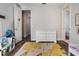 Bedroom with hard floors, a colorful rug and a white dresser, adjacent to two different doors at 9443 Merrifield St, Orlando, FL 32827