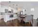 Dining area with a kitchen island, round wood table and four patterned chairs at 9443 Merrifield St, Orlando, FL 32827