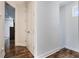 Hallway featuring wood floors and doors to the bedrooms and bathrooms at 9443 Merrifield St, Orlando, FL 32827