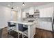 Kitchen features a large island with a beautiful countertop, white cabinets, and modern appliances at 9443 Merrifield St, Orlando, FL 32827