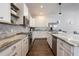 Modern kitchen with stainless steel appliances, white cabinets, granite countertops, and ample counter space at 9443 Merrifield St, Orlando, FL 32827