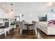Cozy living room with a round wooden table, a sofa, and a view of the kitchen at 9443 Merrifield St, Orlando, FL 32827