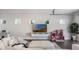 Open living space with sleek entertainment center, cozy white seating, and large windows for natural light at 9443 Merrifield St, Orlando, FL 32827