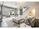 Bright living room boasts a sectional sofa, modern decor, and garage door opening to the outside at 9443 Merrifield St, Orlando, FL 32827