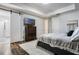 Main bedroom featuring hard floors, TV, sliding door and ensuite bathroom at 9443 Merrifield St, Orlando, FL 32827