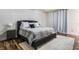 Main bedroom features a comfy bed with gray accents, and modern lighting at 9443 Merrifield St, Orlando, FL 32827