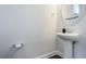 Bright powder room featuring a modern vanity, an oval mirror, and stylish fixtures and accessories at 9443 Merrifield St, Orlando, FL 32827