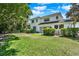 Spacious backyard featuring lush lawn and mature trees surrounding the property at 9743 Covent Garden Dr, Orlando, FL 32827