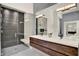 Modern bathroom featuring a double vanity, sleek lighting, glass shower, and contemporary design at 9743 Covent Garden Dr, Orlando, FL 32827