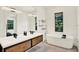 Luxurious bathroom features a double vanity, modern soaking tub, and bright lighting at 9743 Covent Garden Dr, Orlando, FL 32827
