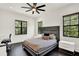 Stylish bedroom features a comfortable bed, dark wood floors, and bright windows at 9743 Covent Garden Dr, Orlando, FL 32827
