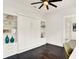 Spare room featuring a Murphy bed, a ceiling fan, hardwood floors, and a bathroom en suite at 9743 Covent Garden Dr, Orlando, FL 32827