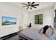 Comfortable bedroom featuring a sleek ceiling fan, large windows, and modern decor at 9743 Covent Garden Dr, Orlando, FL 32827