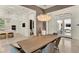 Dining room showcasing a modern chandelier and seamless flow into the kitchen and entryway at 9743 Covent Garden Dr, Orlando, FL 32827
