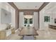 Dining room with a stylish light fixture, neutral décor, and an open layout to the kitchen at 9743 Covent Garden Dr, Orlando, FL 32827