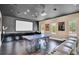 Spacious game room with a ping pong table, movie projector, and comfortable seating at 9743 Covent Garden Dr, Orlando, FL 32827