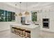 Modern kitchen with large island, breakfast bar seating, stainless steel appliances, and bright windows at 9743 Covent Garden Dr, Orlando, FL 32827