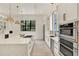 Modern kitchen with a large island, stainless steel appliances, and abundant natural light at 9743 Covent Garden Dr, Orlando, FL 32827