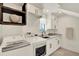 Well-lit laundry room featuring modern washer/dryer units, white cabinetry, and a sink at 9743 Covent Garden Dr, Orlando, FL 32827