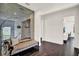 Cozy sitting area showcasing a modern mirror wall, stylish decor, and dark hardwood floors at 9743 Covent Garden Dr, Orlando, FL 32827