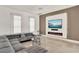 Stylish living room with a comfortable gray sectional sofa and a modern fireplace feature at 9743 Covent Garden Dr, Orlando, FL 32827