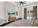 Light-filled bedroom featuring a ceiling fan, dresser, and sliding doors to the outdoor pool area at 9743 Covent Garden Dr, Orlando, FL 32827