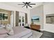Main bedroom with king bed, wooden dresser, ceiling fan, and access to the outside patio at 9743 Covent Garden Dr, Orlando, FL 32827