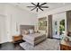 Comfortable main bedroom features a king bed, ensuite bathroom and exterior patio access at 9743 Covent Garden Dr, Orlando, FL 32827