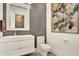 Modern powder room featuring sleek vanity, stylish mirror, and contemporary artwork at 9743 Covent Garden Dr, Orlando, FL 32827