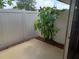View of backyard area with privacy fence, small tropical tree, and concrete patio at 207 Esplanade Way # 101, Casselberry, FL 32707