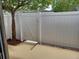 Backyard area with white vinyl fence, tree, and concrete patio at 207 Esplanade Way # 101, Casselberry, FL 32707