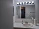 Bright bathroom featuring modern vanity, ample lighting, and decorative mirror at 207 Esplanade Way # 101, Casselberry, FL 32707