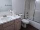 Bathroom with a vanity, mirror, toilet, and tub-shower with glass doors at 207 Esplanade Way # 101, Casselberry, FL 32707