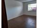 Bright bedroom with tile floor and a window overlooking lush bougainvillea at 207 Esplanade Way # 101, Casselberry, FL 32707