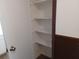 Storage closet with shelves and decorative wood-panel doors at 207 Esplanade Way # 101, Casselberry, FL 32707