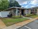Well-maintained home featuring a landscaped yard and inviting entrance at 207 Esplanade Way # 101, Casselberry, FL 32707