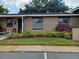 Charming exterior view highlighting landscaping and a quaint facade at 207 Esplanade Way # 101, Casselberry, FL 32707