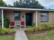 Inviting front porch featuring cozy chairs and colorful landscaping at 207 Esplanade Way # 101, Casselberry, FL 32707