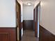 Hallway with decorative wainscotting and neutral color palette throughout at 207 Esplanade Way # 101, Casselberry, FL 32707