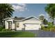 Charming single-story home with a two-car garage, well-manicured lawn, and tropical landscaping at 101 Elena Lavin Cir # 42, Orlando, FL 32807